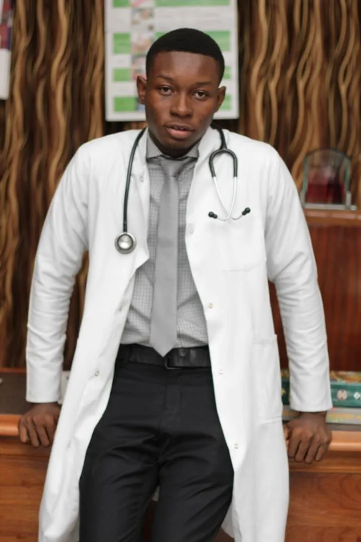 An alumnus in a white coat with a stethoscope