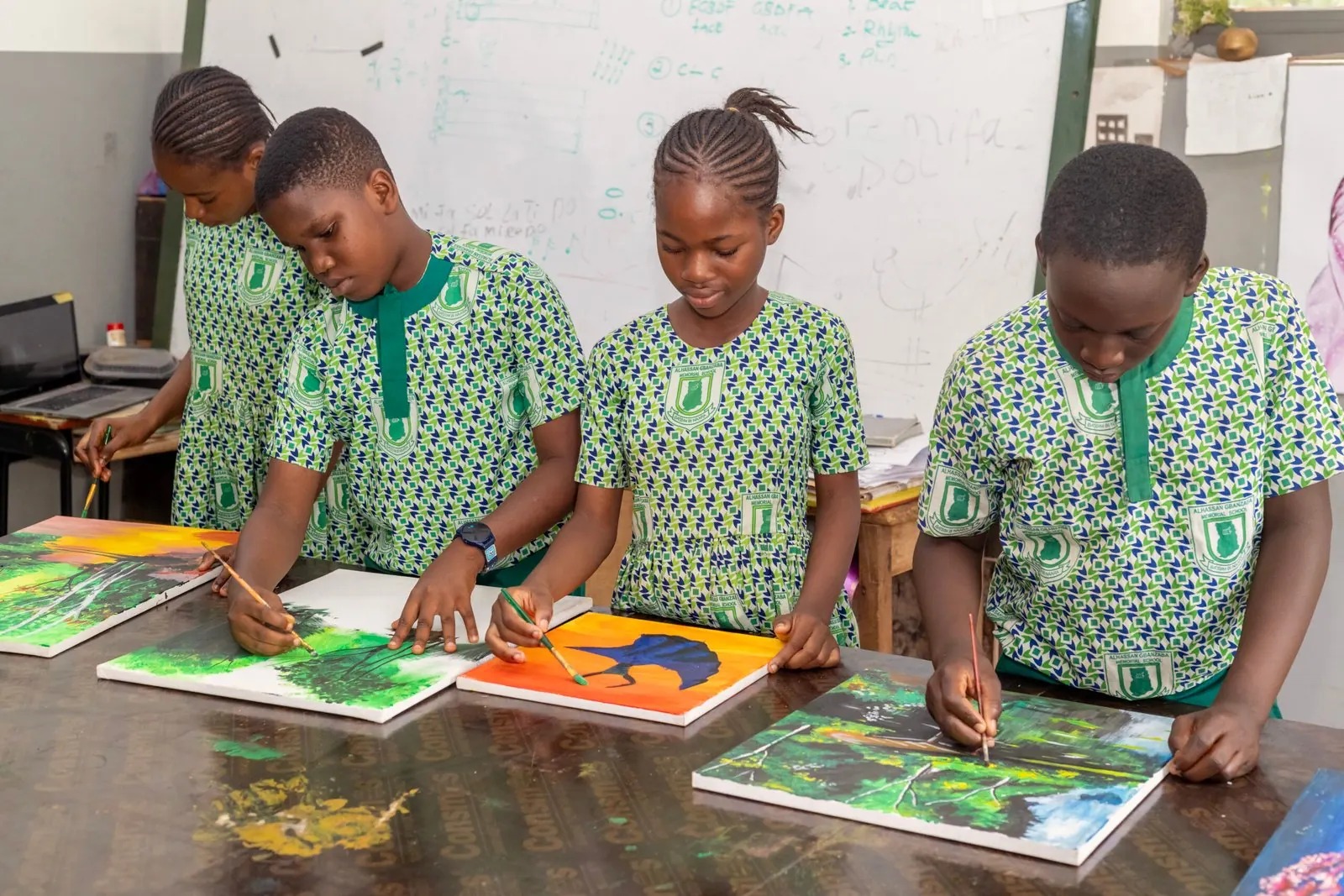 Pupils painting at a long table