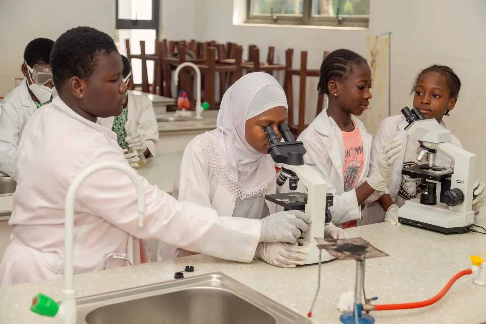 Pupils using microscopes in the science lab